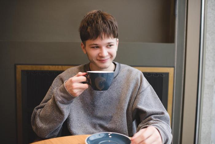 Teenage boy drinking a cup of tea